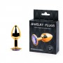 Золотистая анальная пробка с фиолетовым стразом - 7,2 см. (Anal Jewelry Plug GS-15)